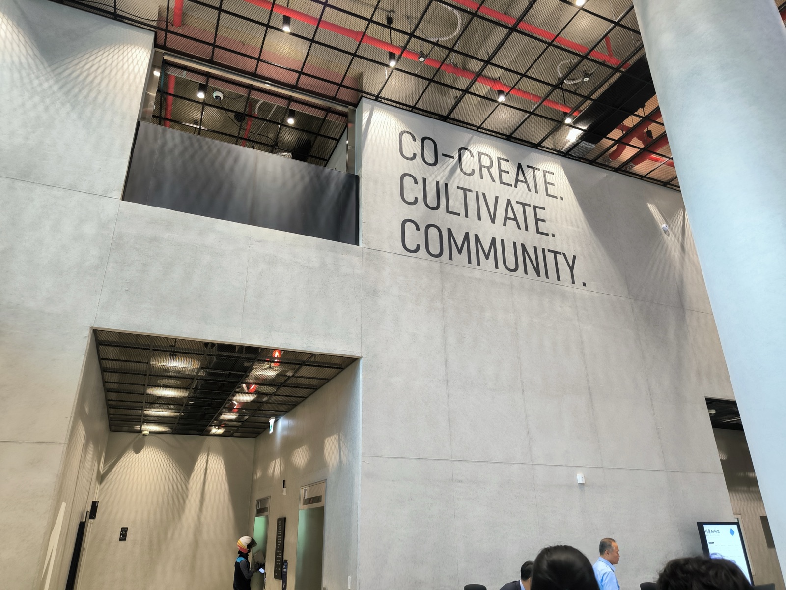 The lobby wall reading Co-create, Cultivate, Community
