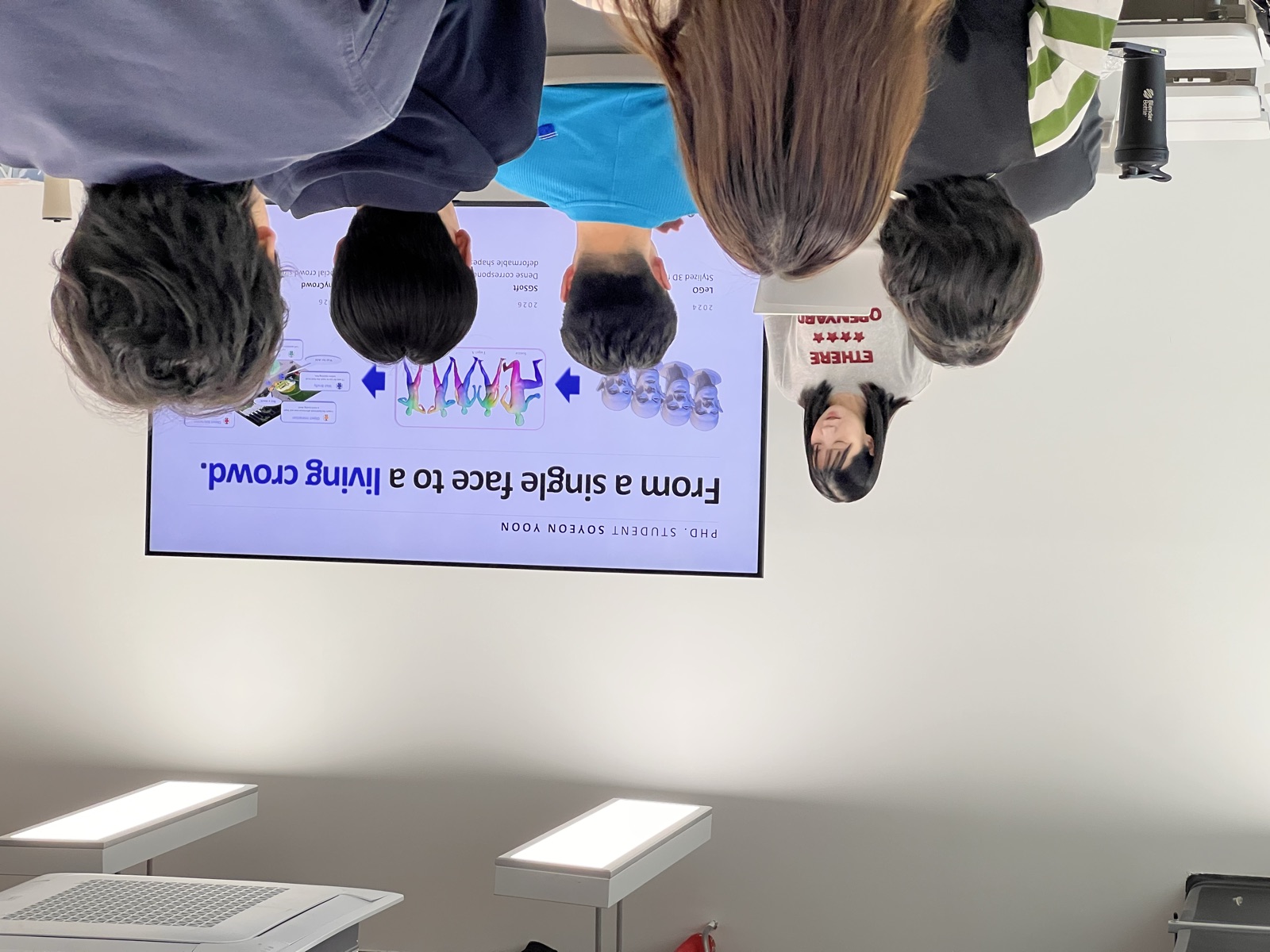 A graduate student presenting on generating crowds from a single face