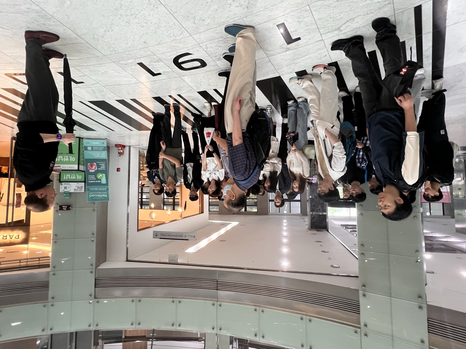 The group gathered on the atrium floor marked 1905