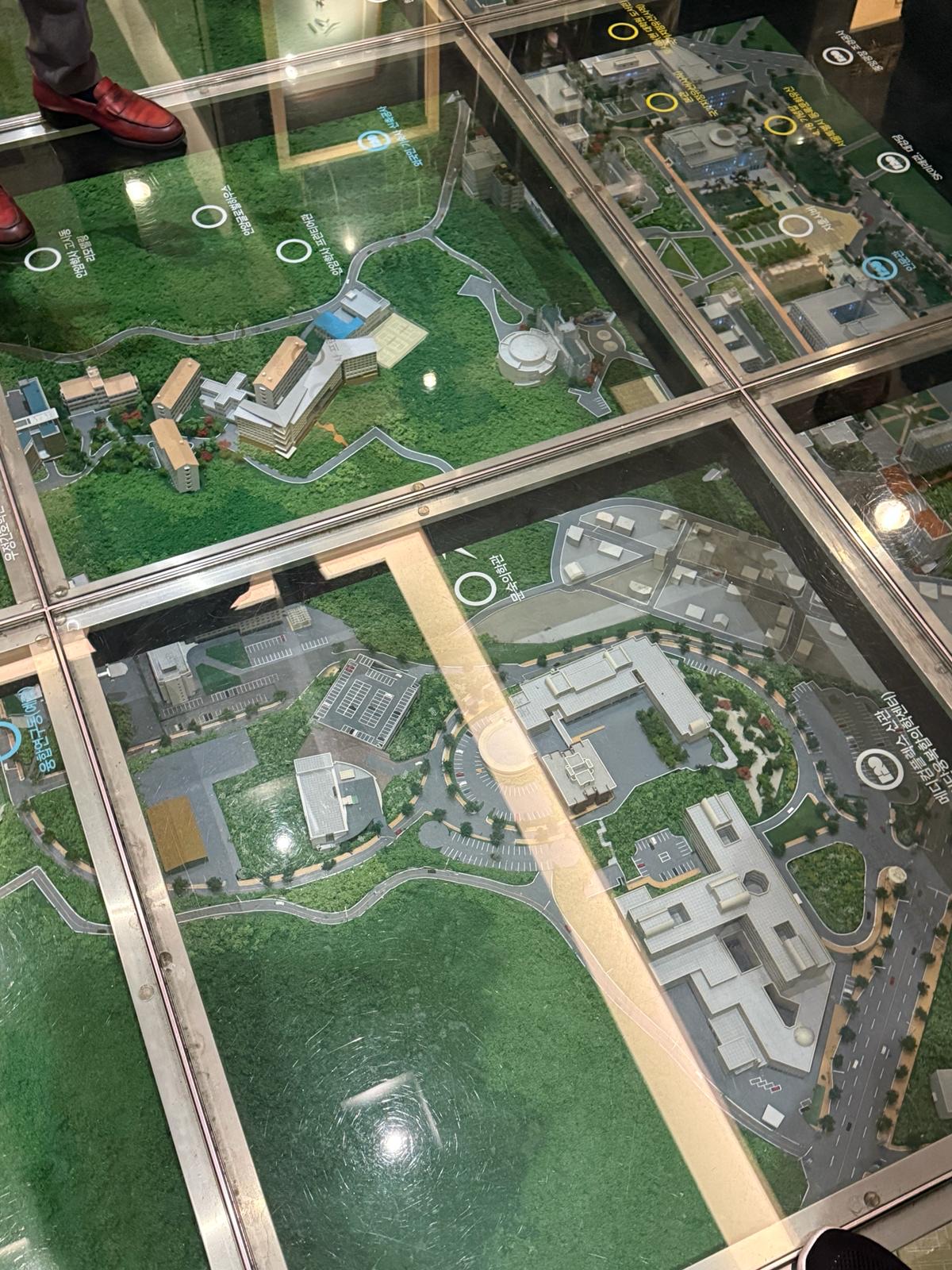 Scale architectural models of the campus under glass