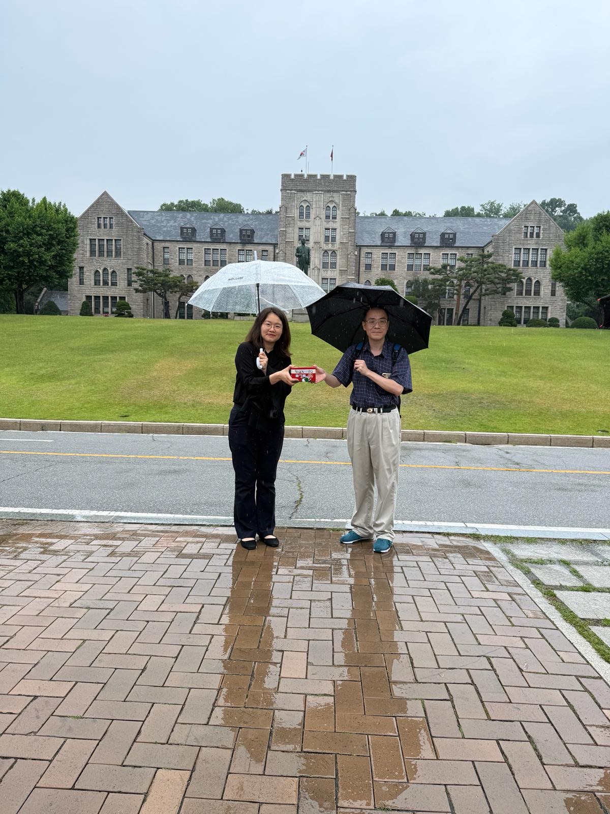 Presenting a souvenir to Dr. William Stewart in front of the main hall