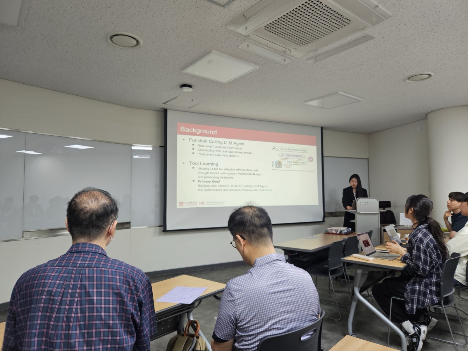 A student presenting research to the seated group