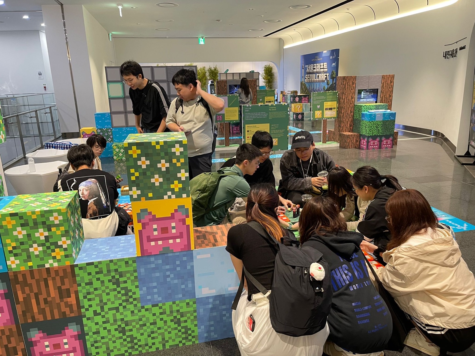 The group crowded round the block-building tables