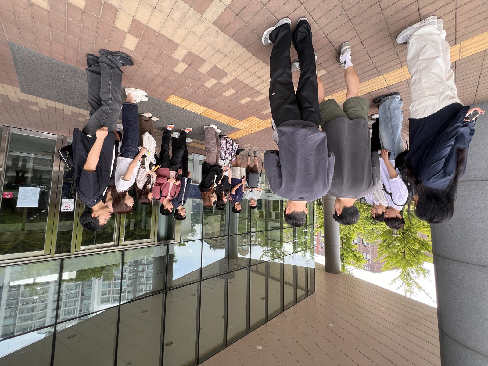 Regrouping outside a glass building entrance