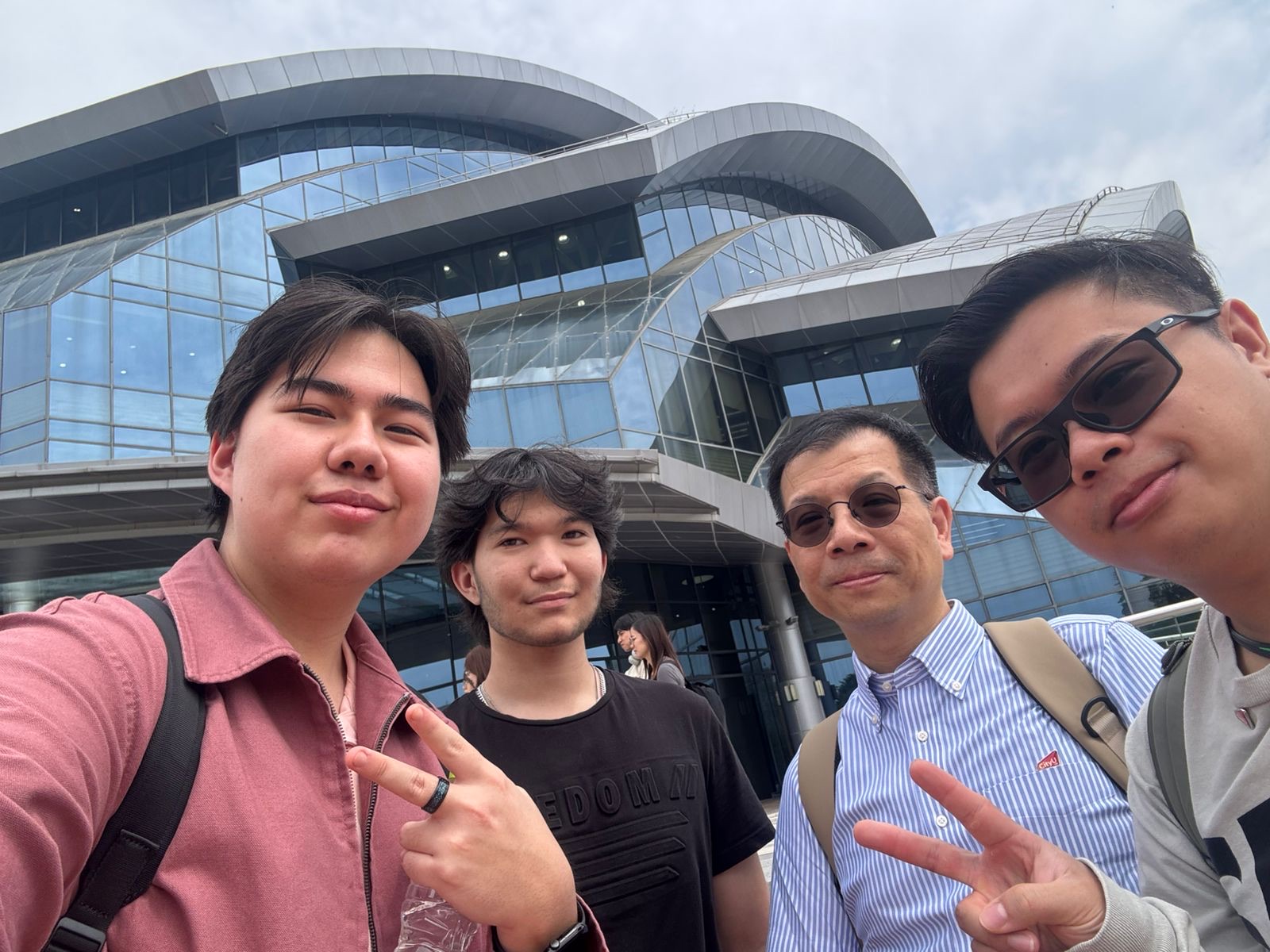 A few of us with our CityU professor in front of the glass building