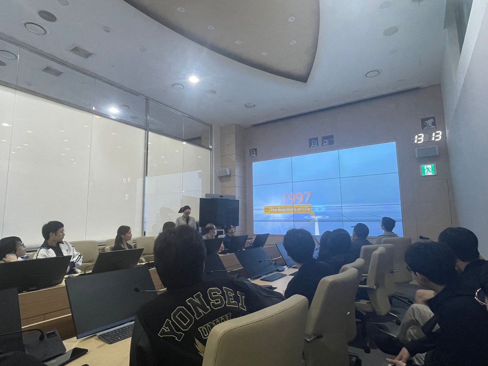The group watching a presentation in the briefing room