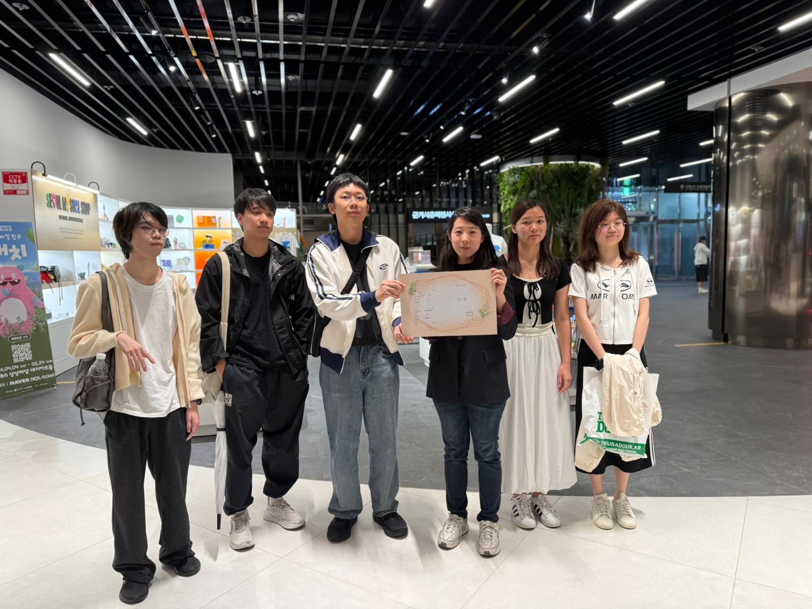 The group in the modern City Hall lobby afterwards